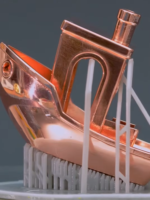 Boat model with a copper-colored metal finish on printing supports
