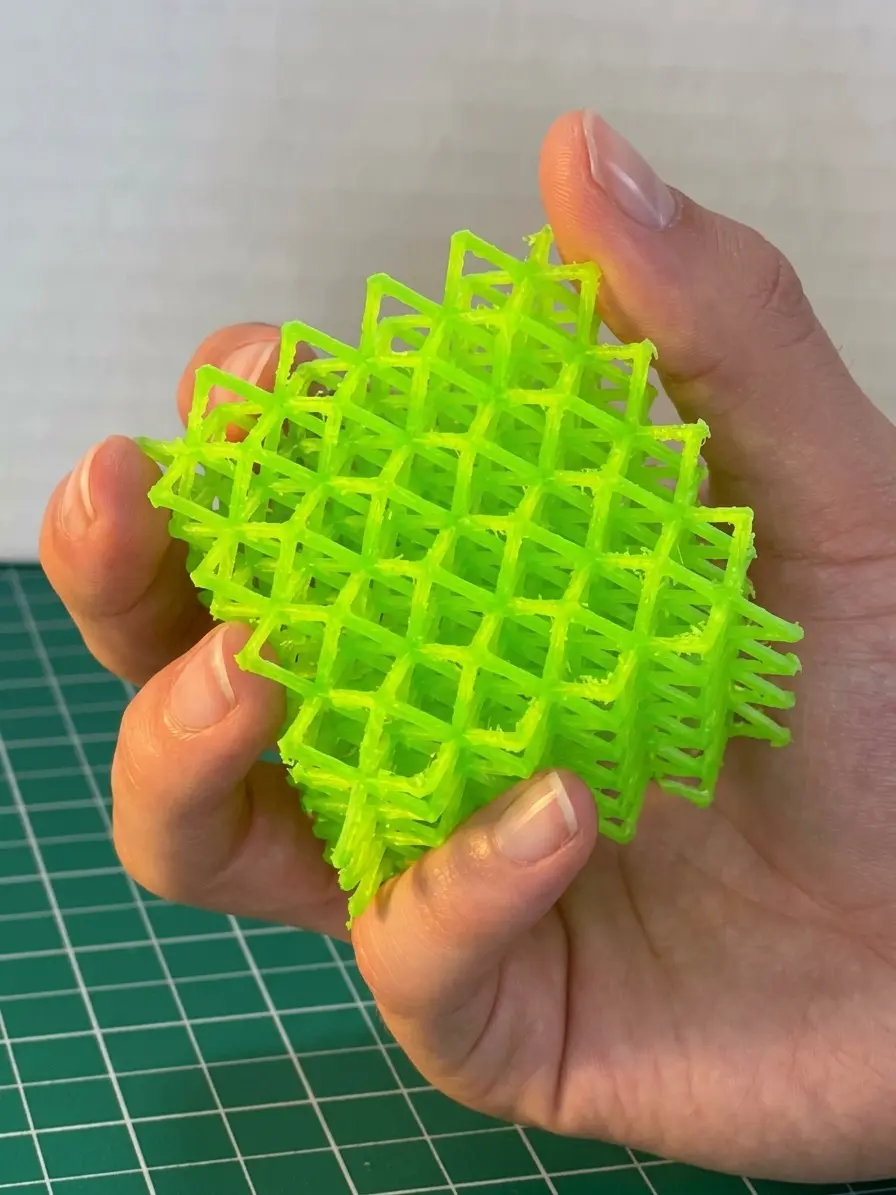 Green TPU lattice held in a hand